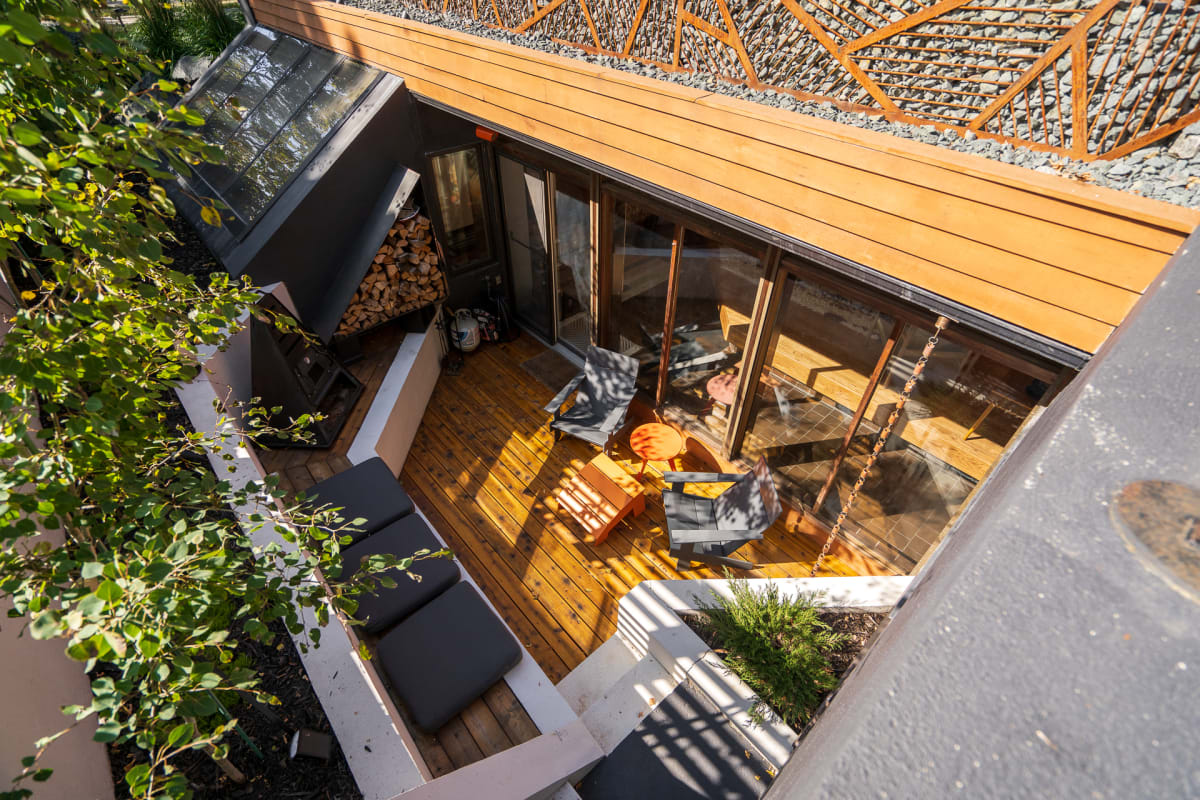 Modern vacation rental with stylish terrace featuring sleek outdoor furniture and contemporary design elements.