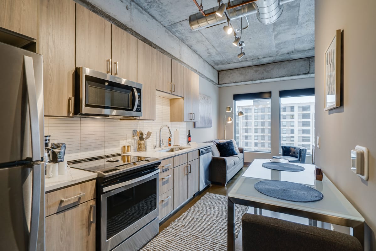 Your sleek modern kitchen flows seamlessly into a cozy living space, perfect for cooking and relaxing together.