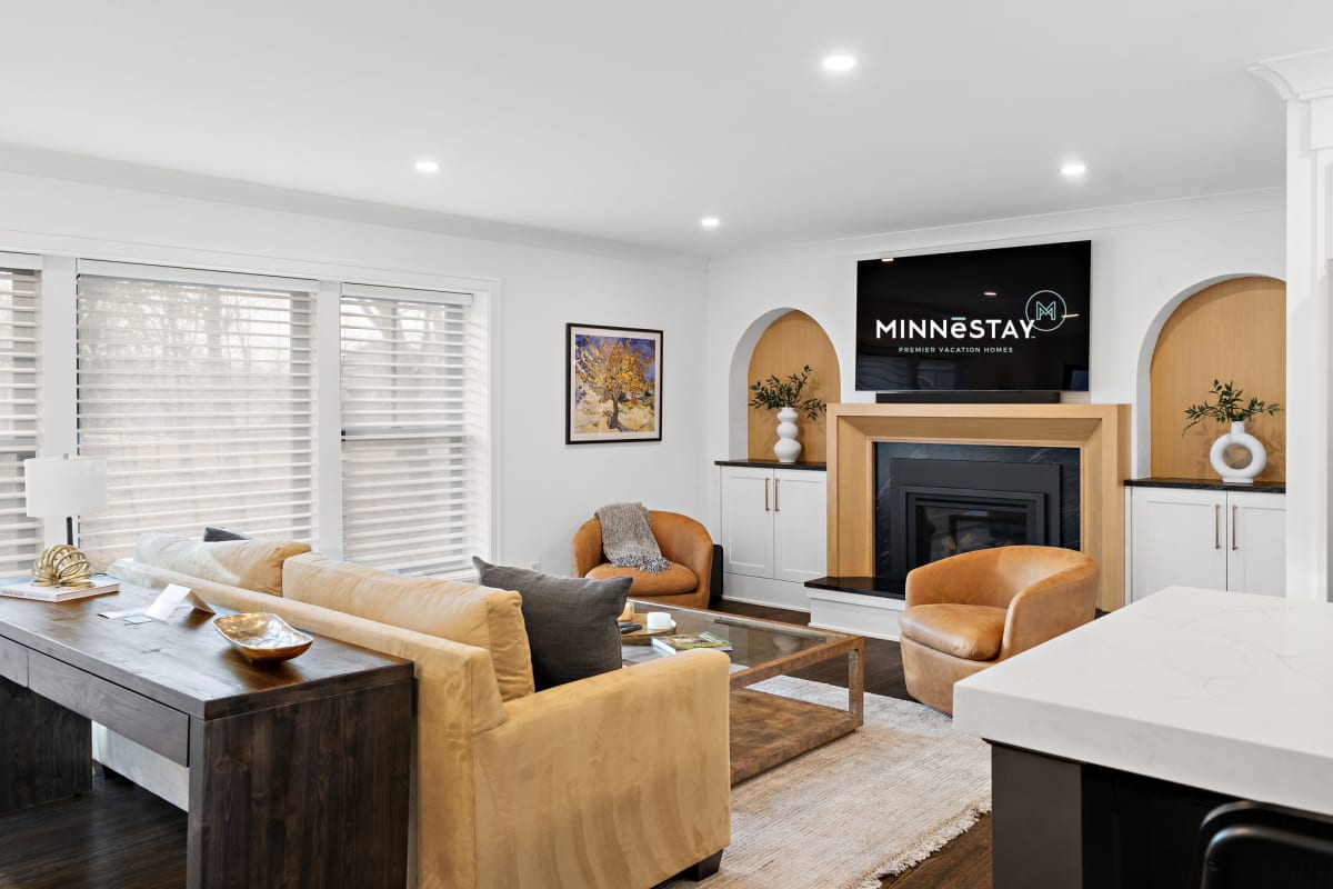 Settle into your elegant living room featuring plush seating, a cozy fireplace, and modern amenities for the perfect relaxing retreat.
