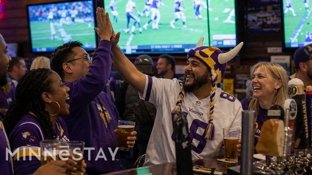 Vikings fans celebrating together at a Minneapolis sports bar.