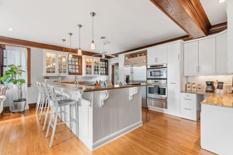 Interior view of a modern kitchen featuring a central island and stainless steel appliances.
