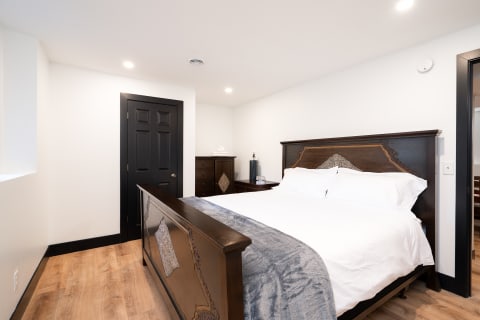 Modern bedroom featuring a wooden bed frame and minimalist decor.