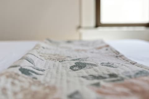 Detailed close-up of soft linens with floral patterns on a bed.