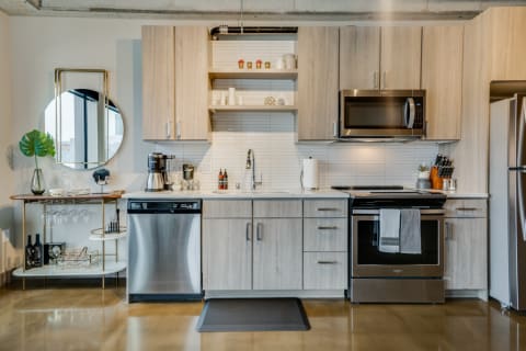 Contemporary kitchen with light wood cabinets and stainless-steel appliances.