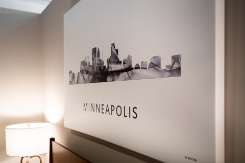Abstract art of Minneapolis skyline with warm lamp in foreground.