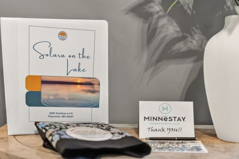 Welcoming setup at a vacation rental with a property information folder and thank you card.