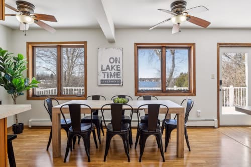 Gather around this bright dining space with stunning lake views through every window, perfect for your group meals and game nights.