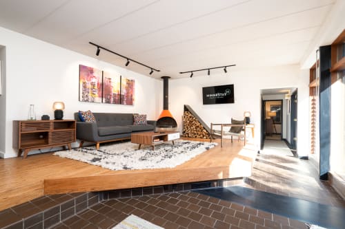 Relax in your stylish living space featuring a cozy fireplace, modern furnishings, and warm wood accents that create the perfect atmosphere for unwinding.