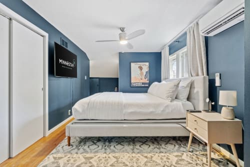 Sink into crisp white linens surrounded by calming blue walls. Your private retreat features modern amenities and stylish touches for the perfect night's rest.
