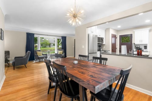 Gather around your beautiful reclaimed wood dining table where memorable meals and conversations await in this stylish open-concept space.
