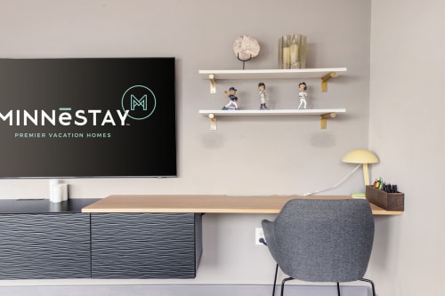 Your dedicated workspace features a sleek desk, modern chair, and wall-mounted TV—perfect for staying productive during your stay.