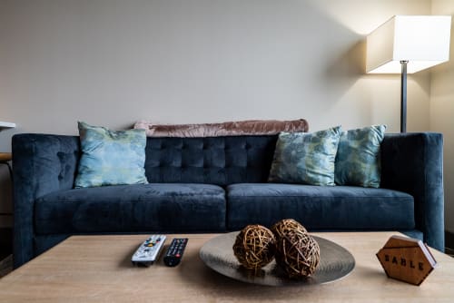 Sink into this plush velvet sofa where soft textures and elegant touches create your perfect spot for relaxation.