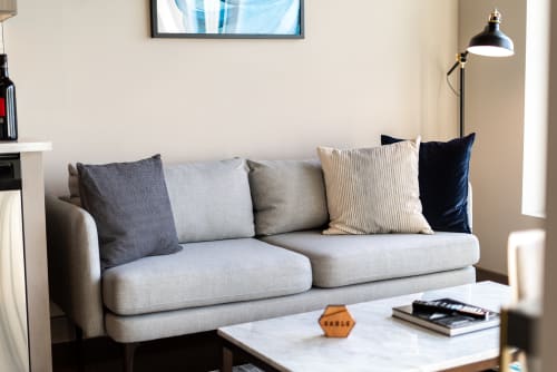 Sink into this plush sofa with curated pillows and settle in for your perfect evening of relaxation and entertainment.
