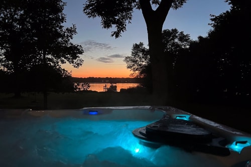 Relax in the hot tub at night while enjoying a beautiful sunset over Lake Owasso.