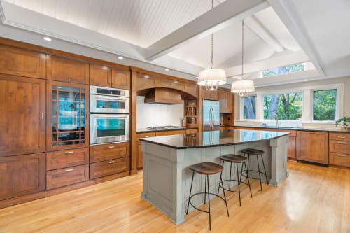Your gourmet kitchen awaits with rich wood cabinetry, granite counters, and a central island perfect for cooking and gathering together.