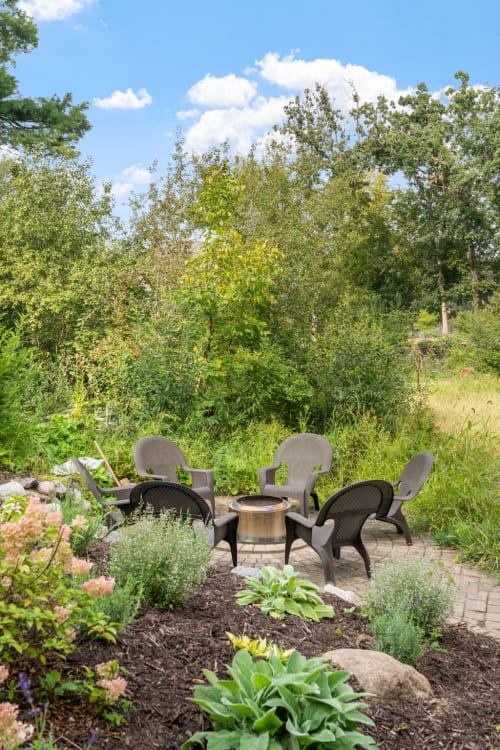 Relax in your private garden oasis surrounded by lush plantings and mature trees, where comfortable seating awaits your morning coffee or evening conversations.
